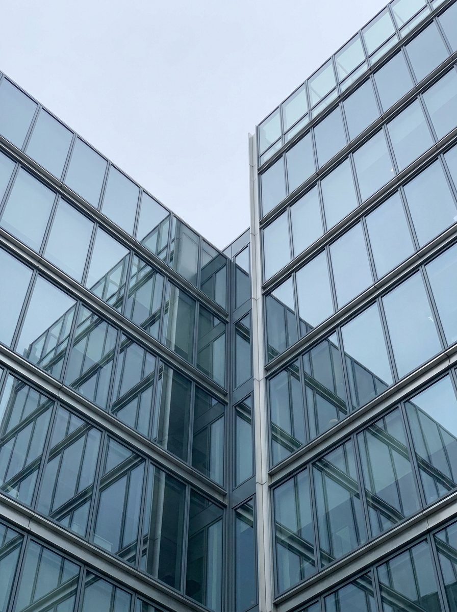 Glass facades of two modern office buildings